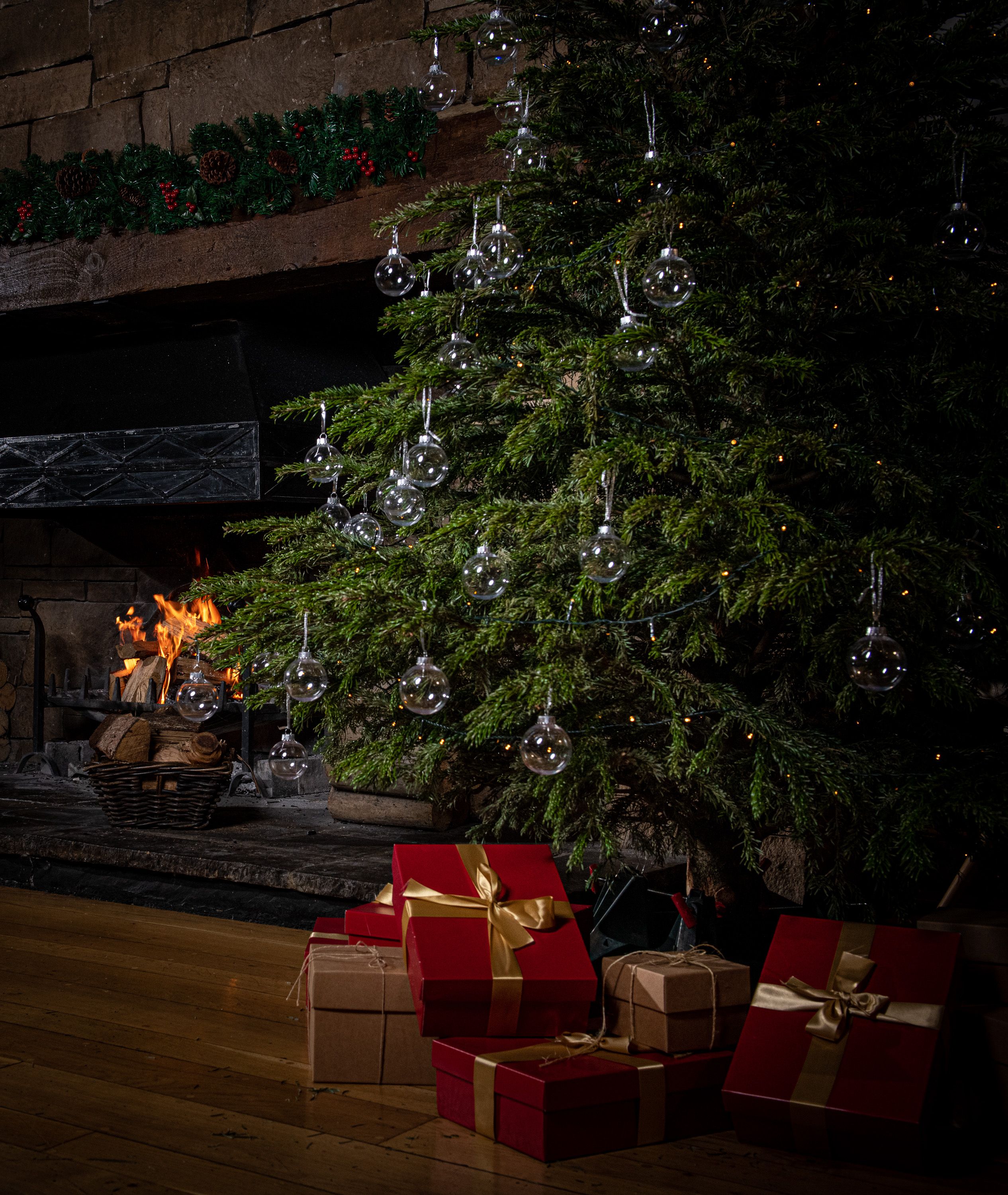 A Christmas tree adorned in ornaments, with presents beneath it