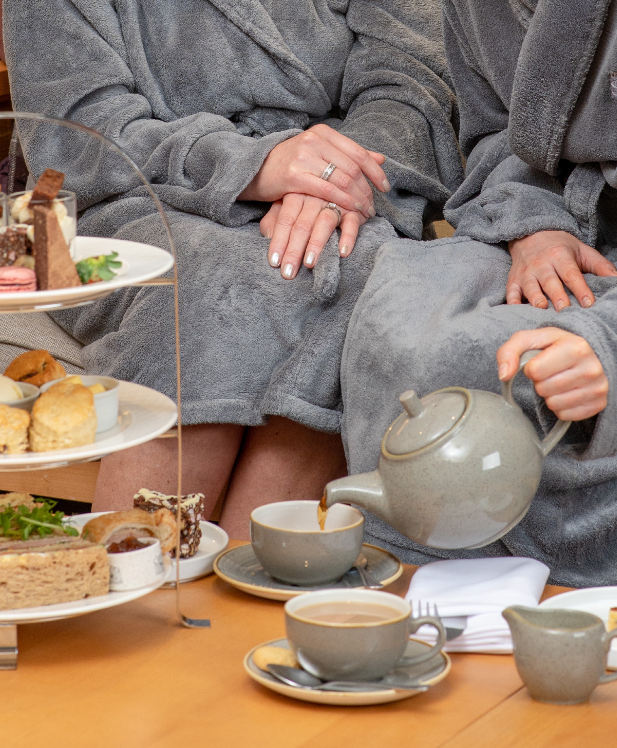 Women pouring tea enjoying afternoon tea