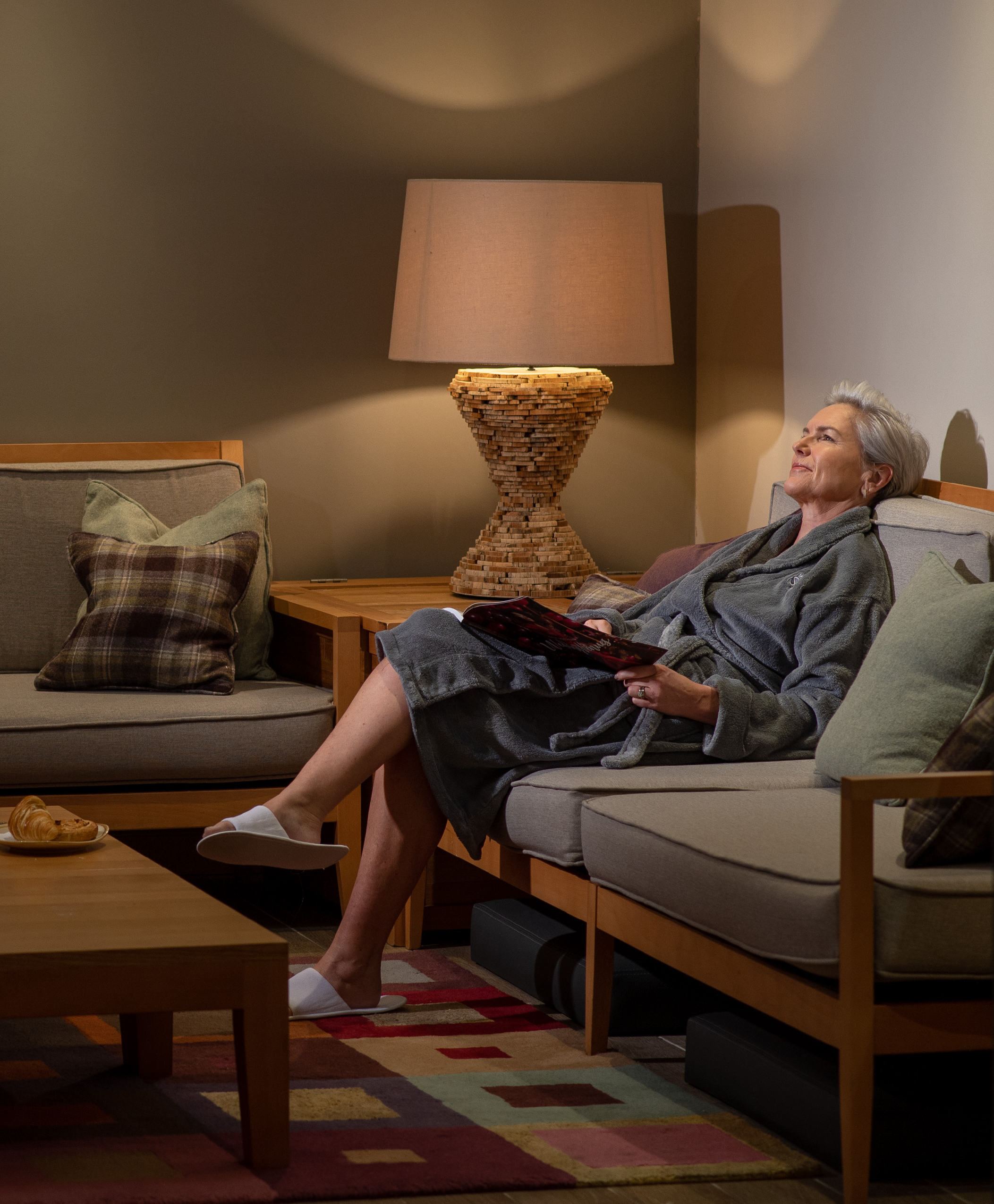 Woman relaxing in spa reading a magazine