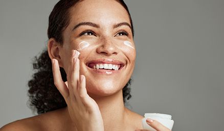 Woman applying skincare