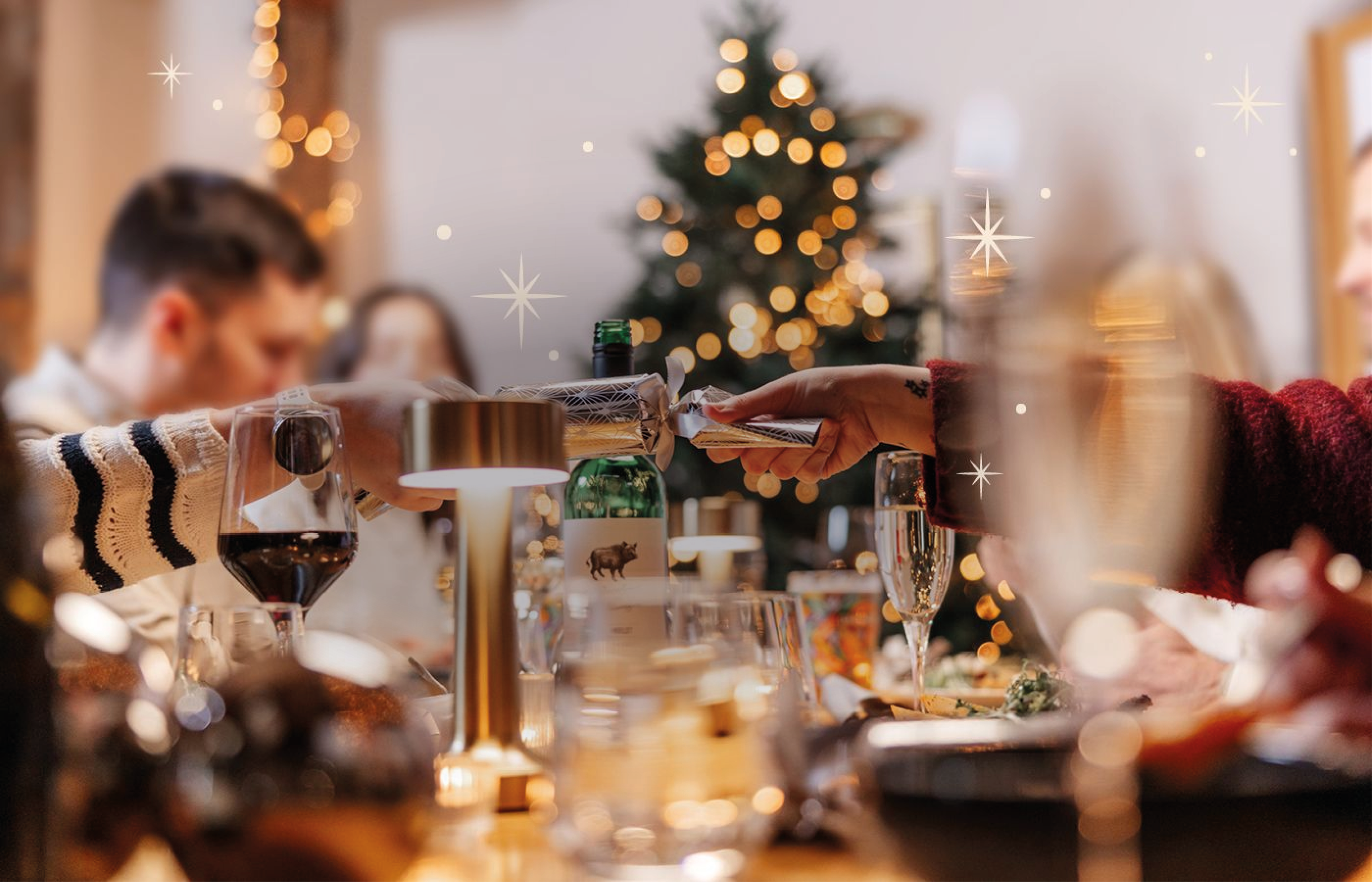 Christmas cracker being pulled at festive table